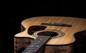 Close-up of a classical acoustic guitar on a black background